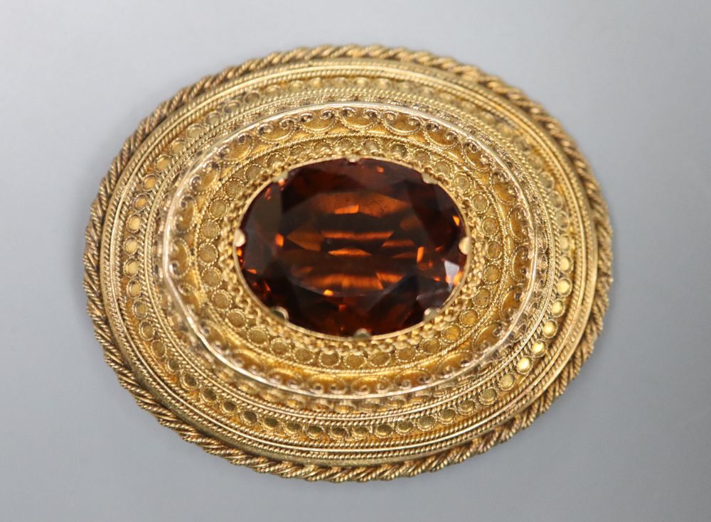 A Victorian yellow metal and citrine set oval brooch, with cannetile work decoration, 41mm, gross 11.3 grams.